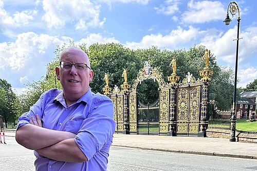 Graham standing in front of Warrington's Golden Gates